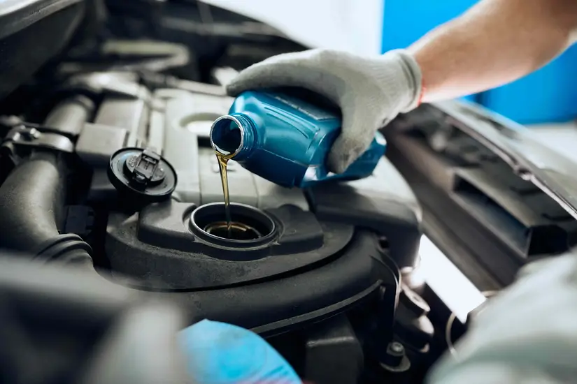 Man repairing damaged car at auto body shop